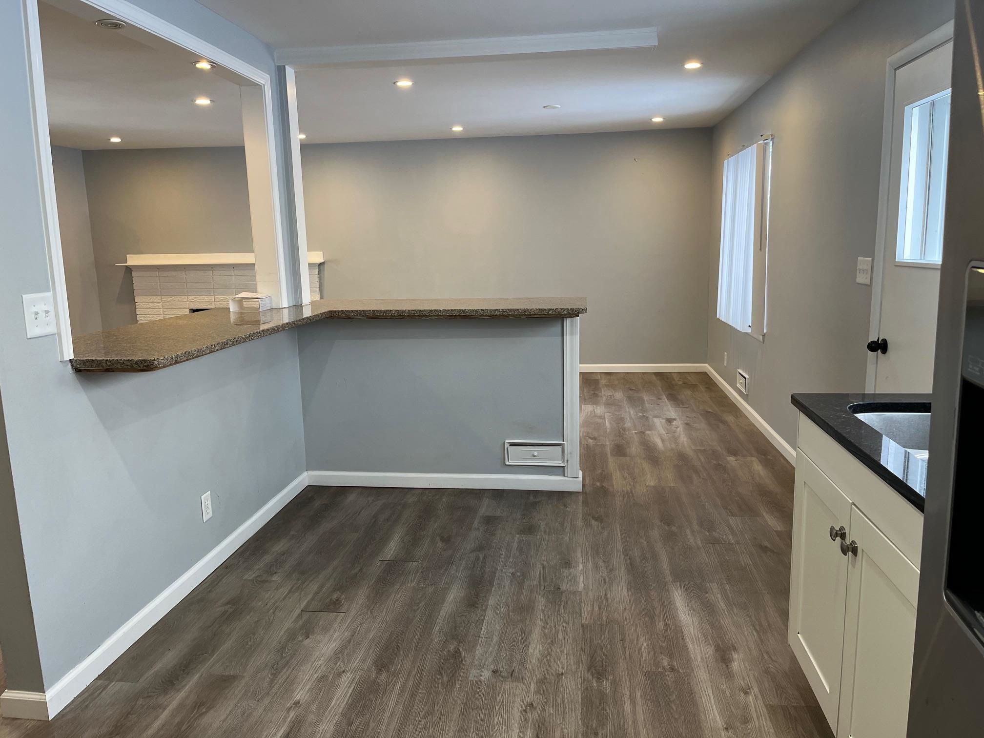 4909 Mohawk Road Rockford, IL 61107 - Photo 9 of 44 an empty room with wooden floor and windows