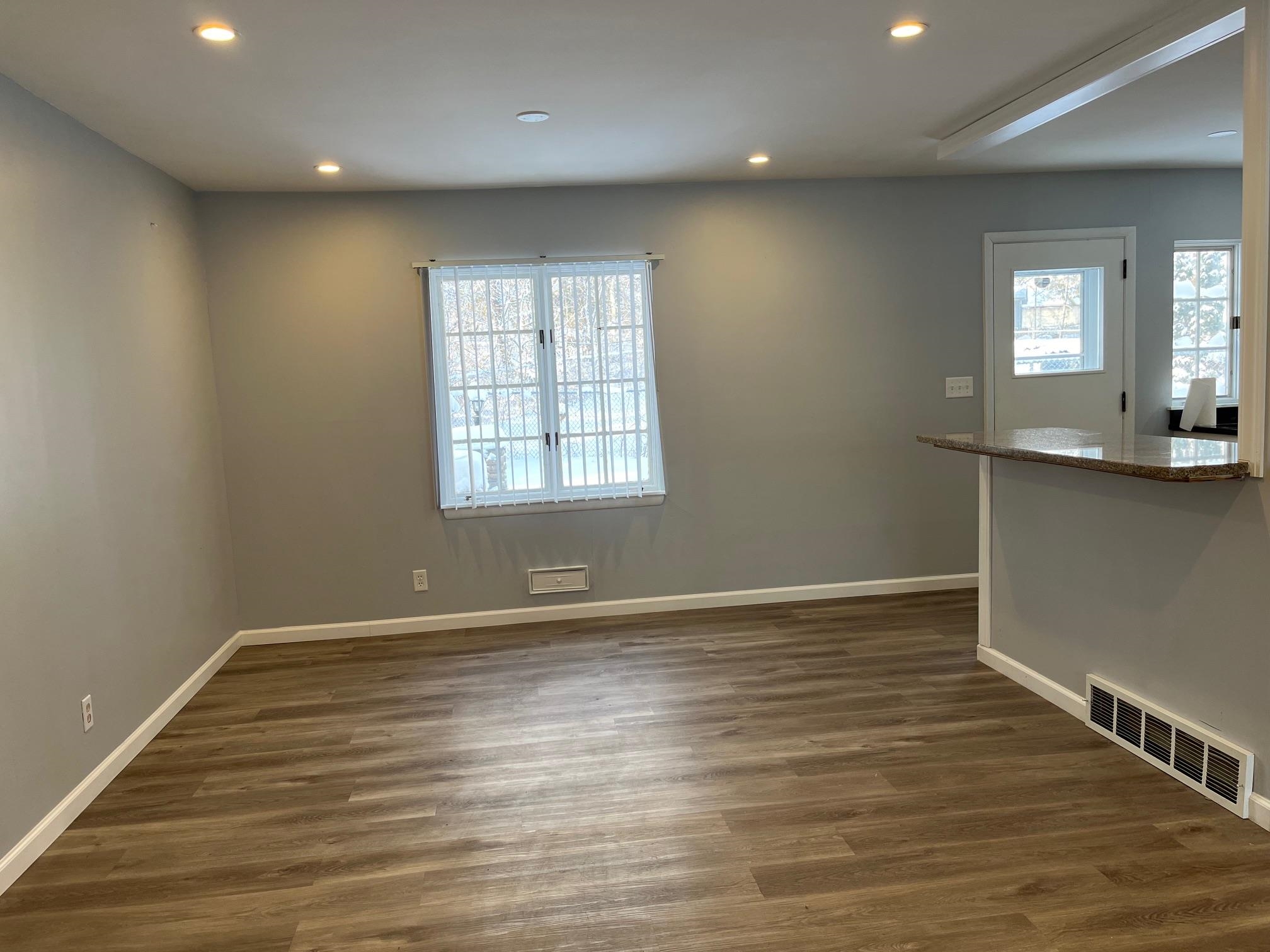 4909 Mohawk Road Rockford, IL 61107 - Photo 10 of 44 an empty room with wooden floor and windows