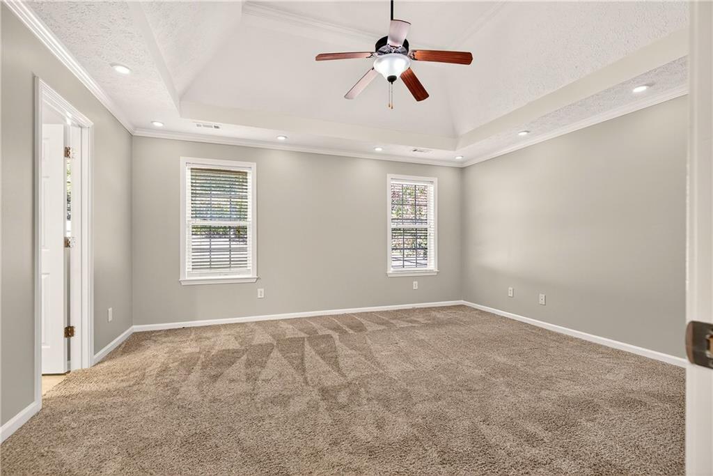 220 Windpher Ridge Hampton, GA 30228 - Photo 11 of 42 an empty room with windows and ceiling fan
