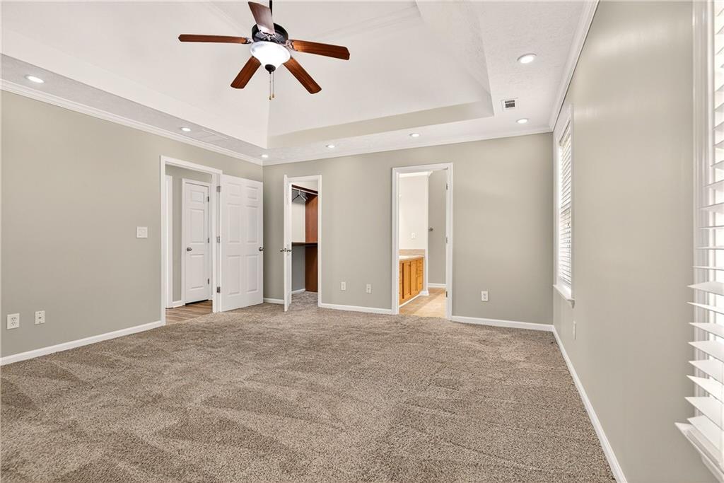 220 Windpher Ridge Hampton, GA 30228 - Photo 12 of 42 an empty room with chandelier fan and windows