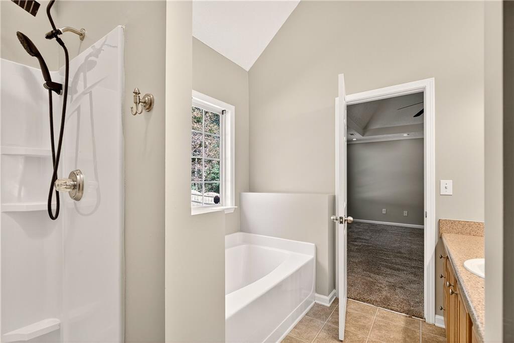 220 Windpher Ridge Hampton, GA 30228 - Photo 15 of 42 a bathroom with a tub shower and a sink