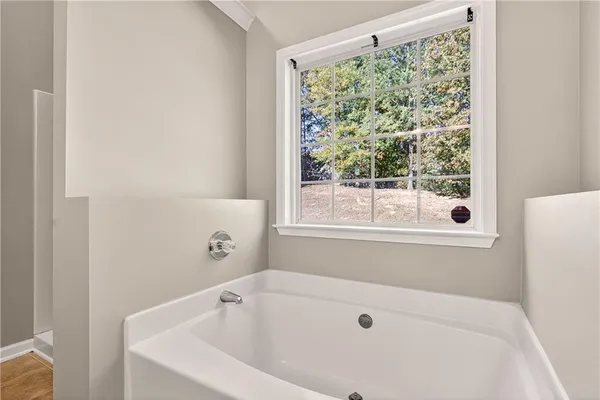 a bathroom with a bathtub and window