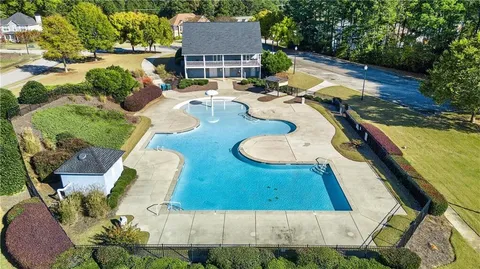 an aerial view of a house with yard swimming pool and outdoor seating