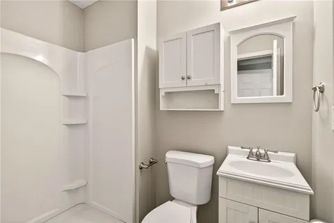 a bathroom with a sink toilet and mirror