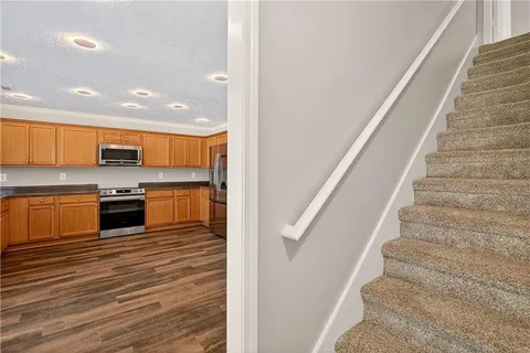 a view of kitchen with sink and refrigerator