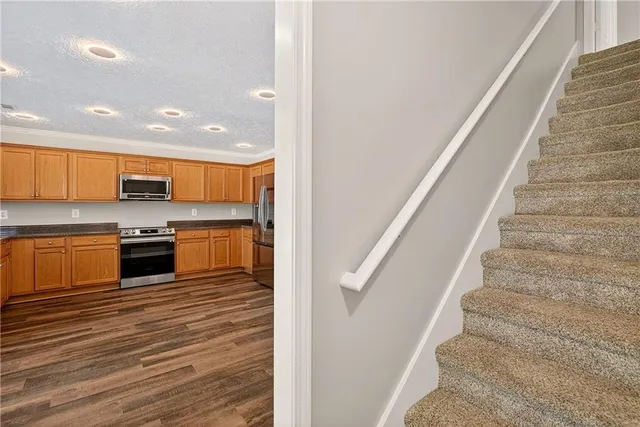 a view of kitchen with sink and refrigerator