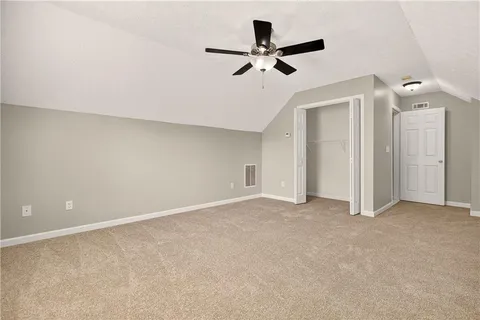 a view of a livingroom with a ceiling fan and wooden floor