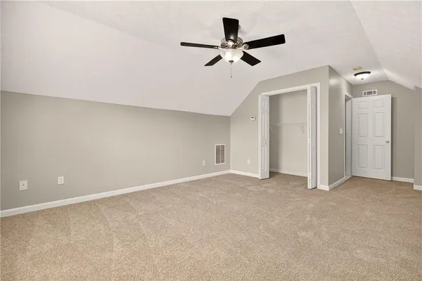 a view of a livingroom with a ceiling fan and wooden floor