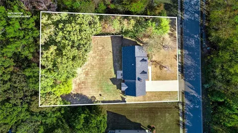 an aerial view of a house with a yard and lake view