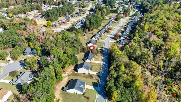 an aerial view of a house with yard swimming pool and outdoor seating