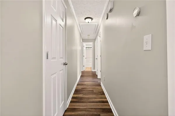 a view of a hallway with wooden floor and entryway