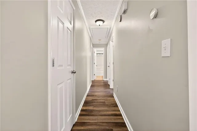 a view of a hallway with wooden floor and entryway