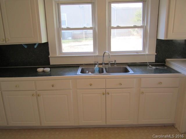 605 Blacksnake Road Stanley, NC 28164 - Photo 14 of 15 a kitchen with granite countertop white cabinets and window