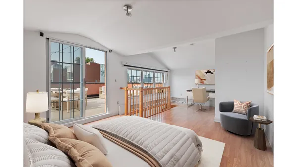 a bedroom with a bed and a large window