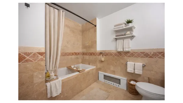 a kitchen with stainless steel appliances granite countertop a refrigerator a stove and a sink