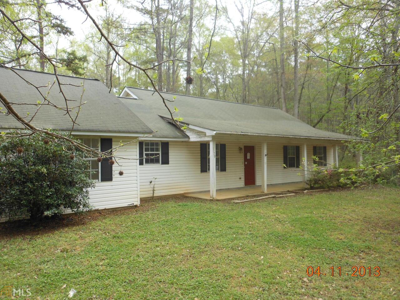 1179 Roscoe Road Newnan, GA 30263 - Photo 1 of 1 a front view of a house with a garden