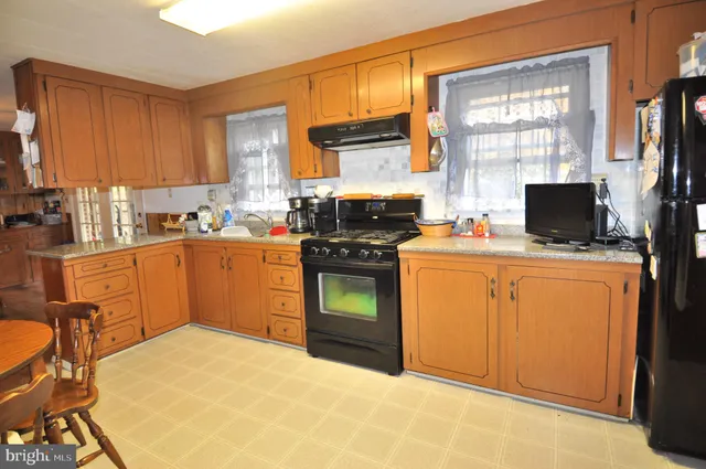 a kitchen with a stove a sink and a microwave