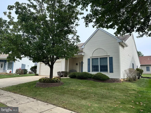 a view of a yard in front view of a house