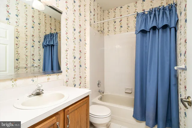 a bathroom with a sink toilet tub and shower