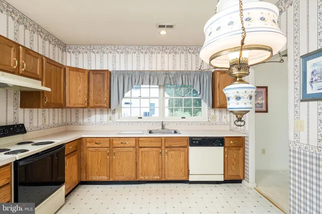 a kitchen with a sink window and cabinets