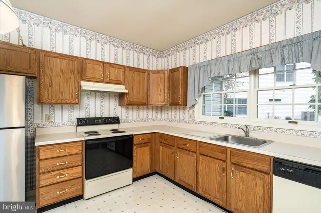 a kitchen with a sink stove and cabinets