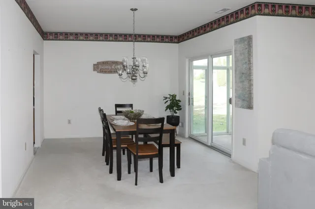 a view of a dining room with furniture and window