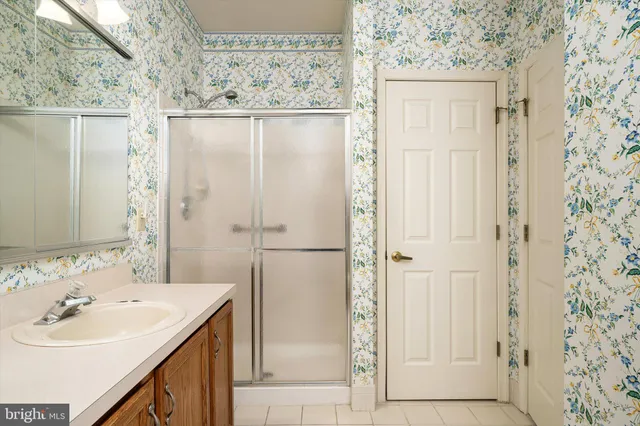 a bathroom with a sink a mirror and a shower
