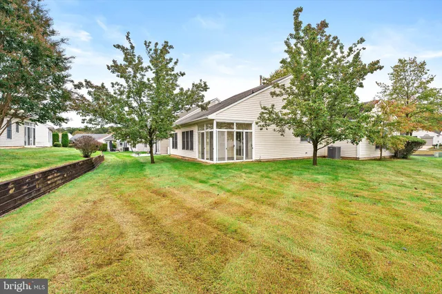 a view of house with backyard