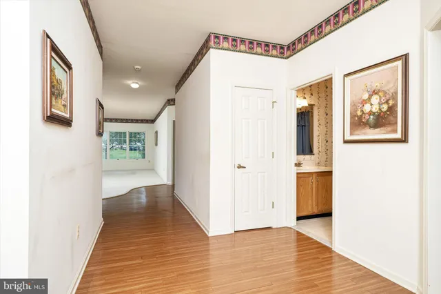 a view of a hallway with wooden floor