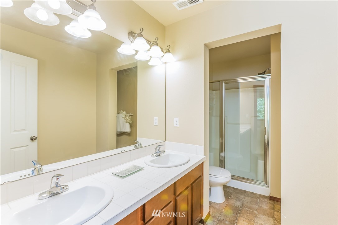 1129 215th Place Southeast Bothell, WA 98021 - Photo 14 of 20 a bathroom with a double vanity sink and a mirror