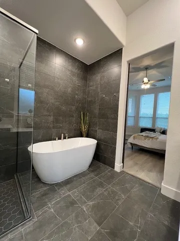 a bathroom with a bathtub and shower