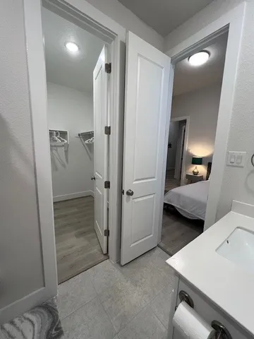 a view of a hallway with bathroom
