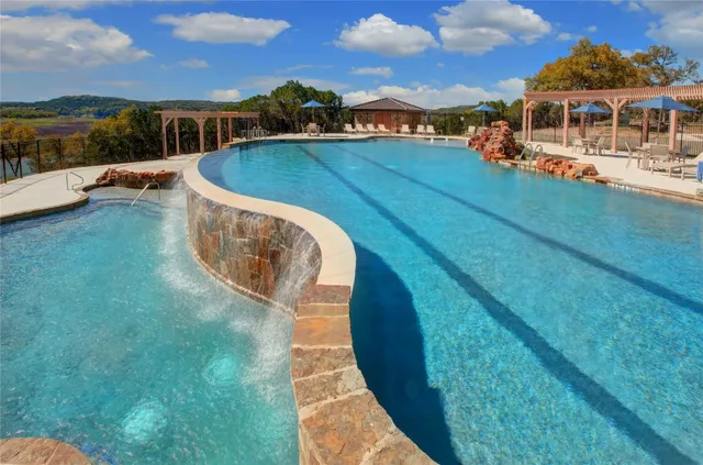 a view of a swimming pool with a yard