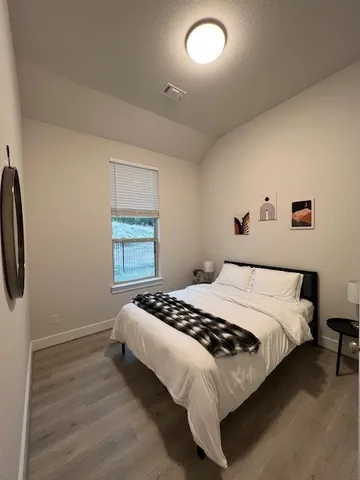 a bedroom with a bed and dresser