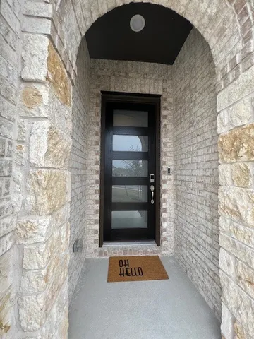 a room with a door and a shower