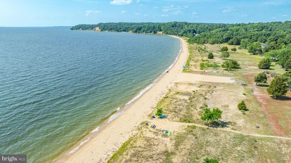 an aerial view of residential houses with outdoor space and trees all around