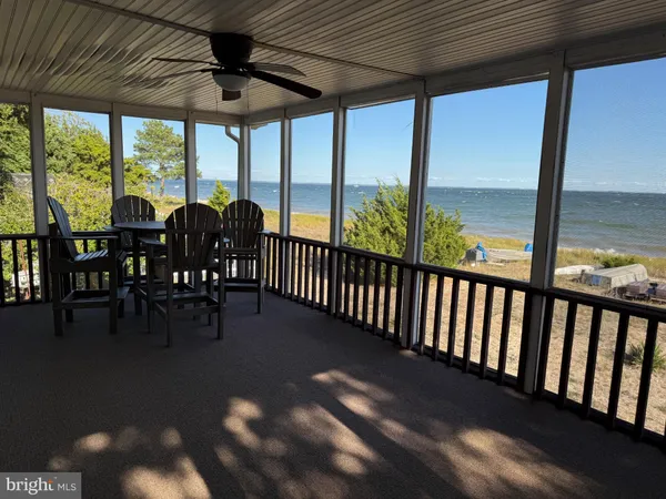 a view of a porch with chairs and backyard