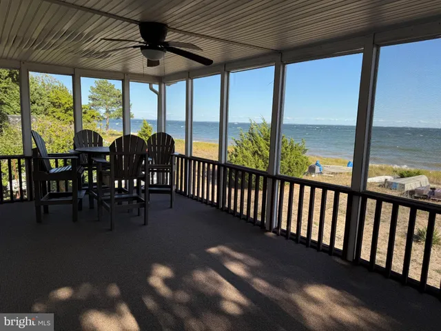 a view of a porch with chairs and backyard