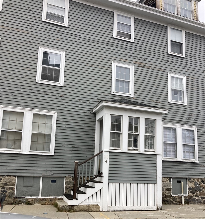 4 Town House Square, Unit 2 Marblehead, MA 01945 - Photo 1 of 1 a view of a building next to a yard