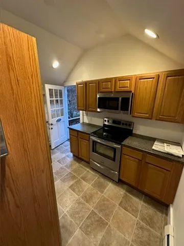 a kitchen with stainless steel appliances a cabinets and a table