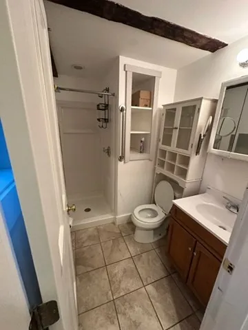 a bathroom with a toilet and a shower