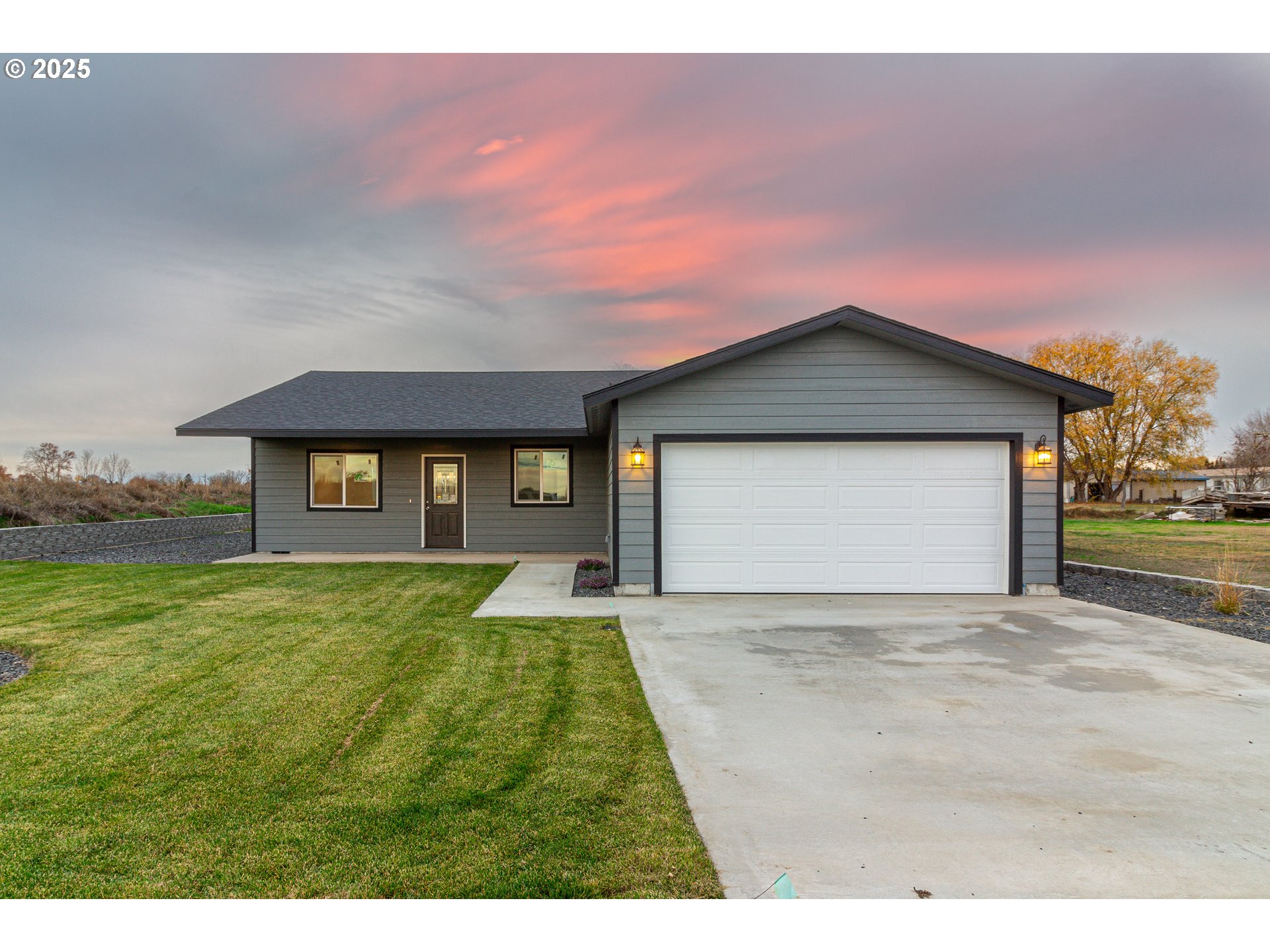 435 Northeast Sloan Street Stanfield, OR 97875 - Photo 1 of 24 a view of a house with a yard and garage