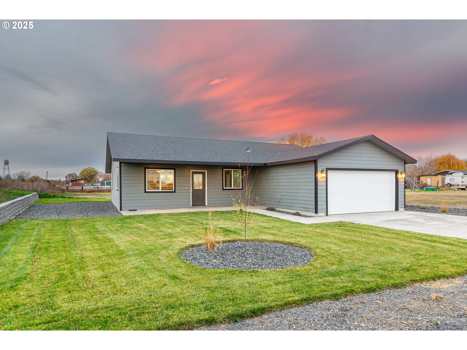 435 Northeast Sloan Street Stanfield, OR 97875 - Photo 15 of 24 a view of a house with a yard and garage