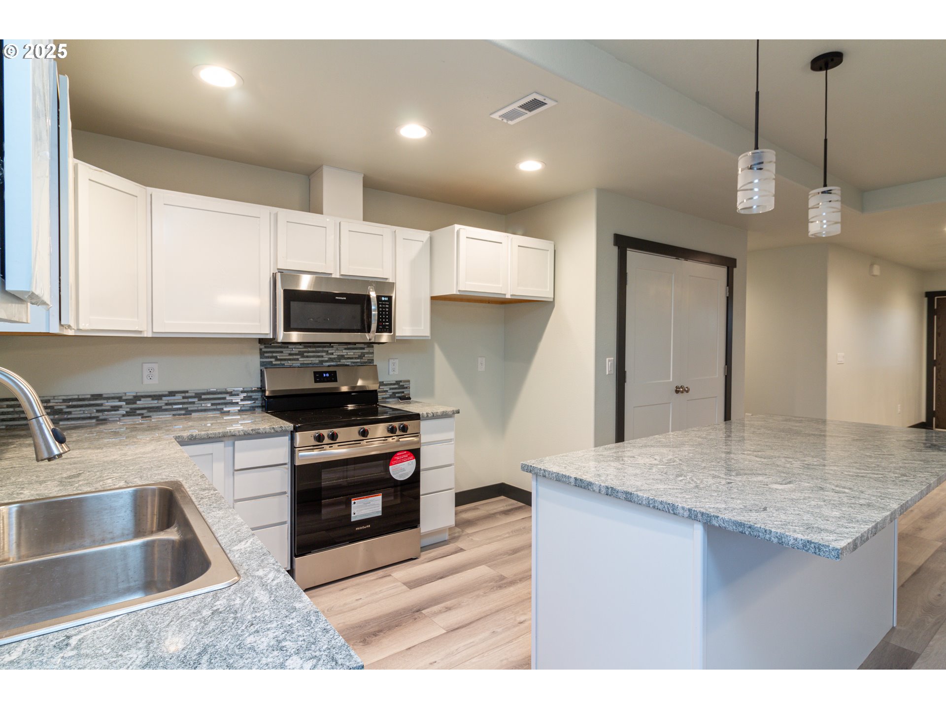 435 Northeast Sloan Street Stanfield, OR 97875 - Photo 21 of 24 a kitchen with stainless steel appliances granite countertop a sink a stove and a microwave