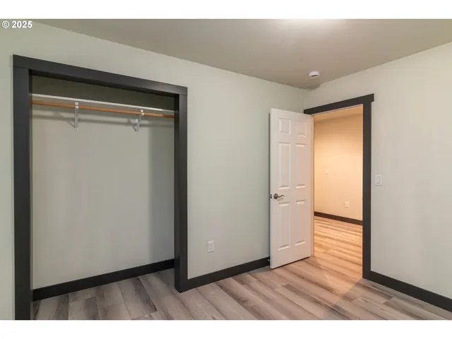 a view of an empty room and wooden floor