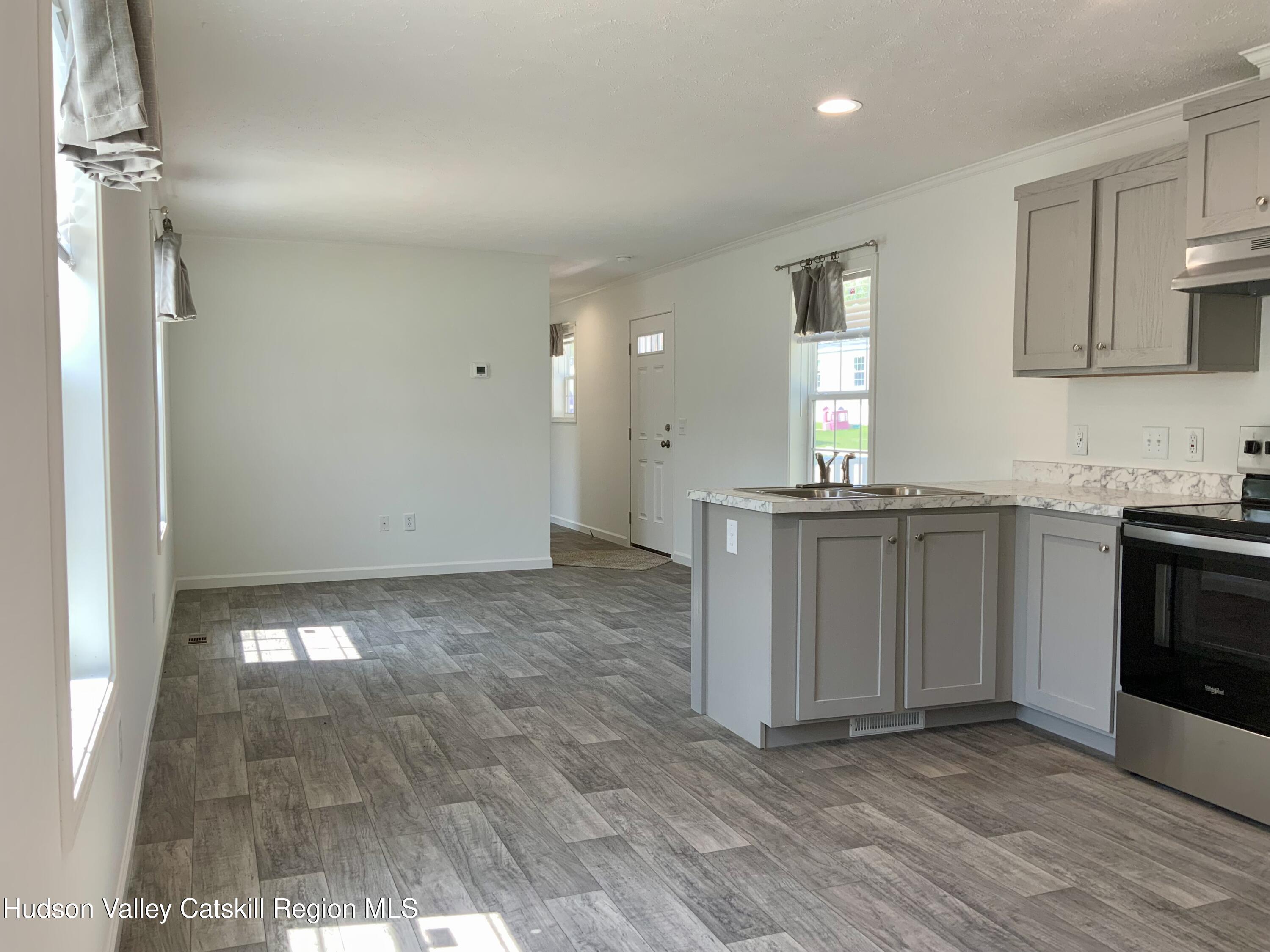 1154 Us-9, Unit 23 Hudson, NY 12534 - Photo 6 of 23 a view of a kitchen with a sink and dishwasher wooden floor