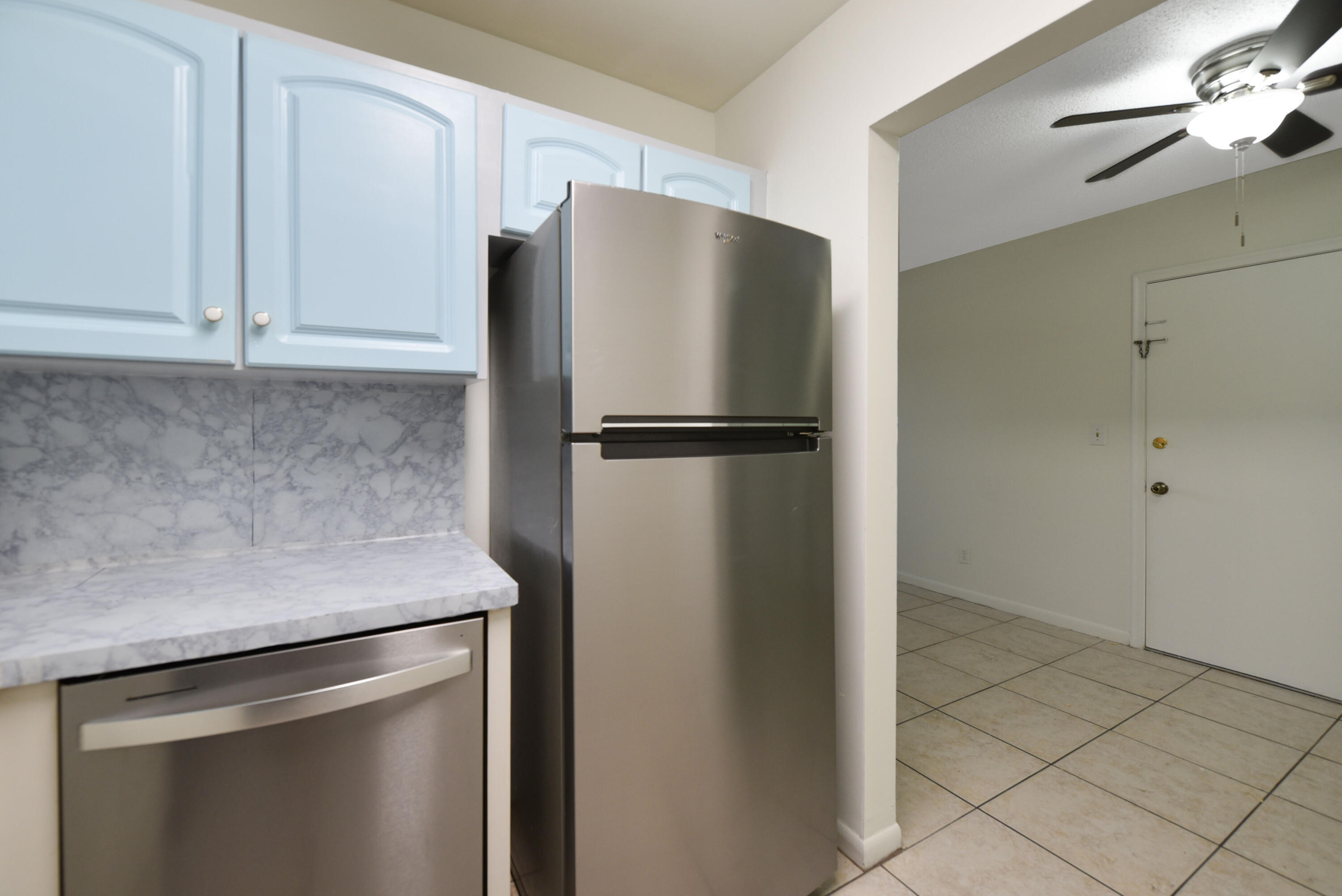 298 Southwest 6th Street, Unit 110 Boca Raton, FL 33432 - Photo 12 of 27 a white refrigerator freezer and a stove sitting inside of a kitchen