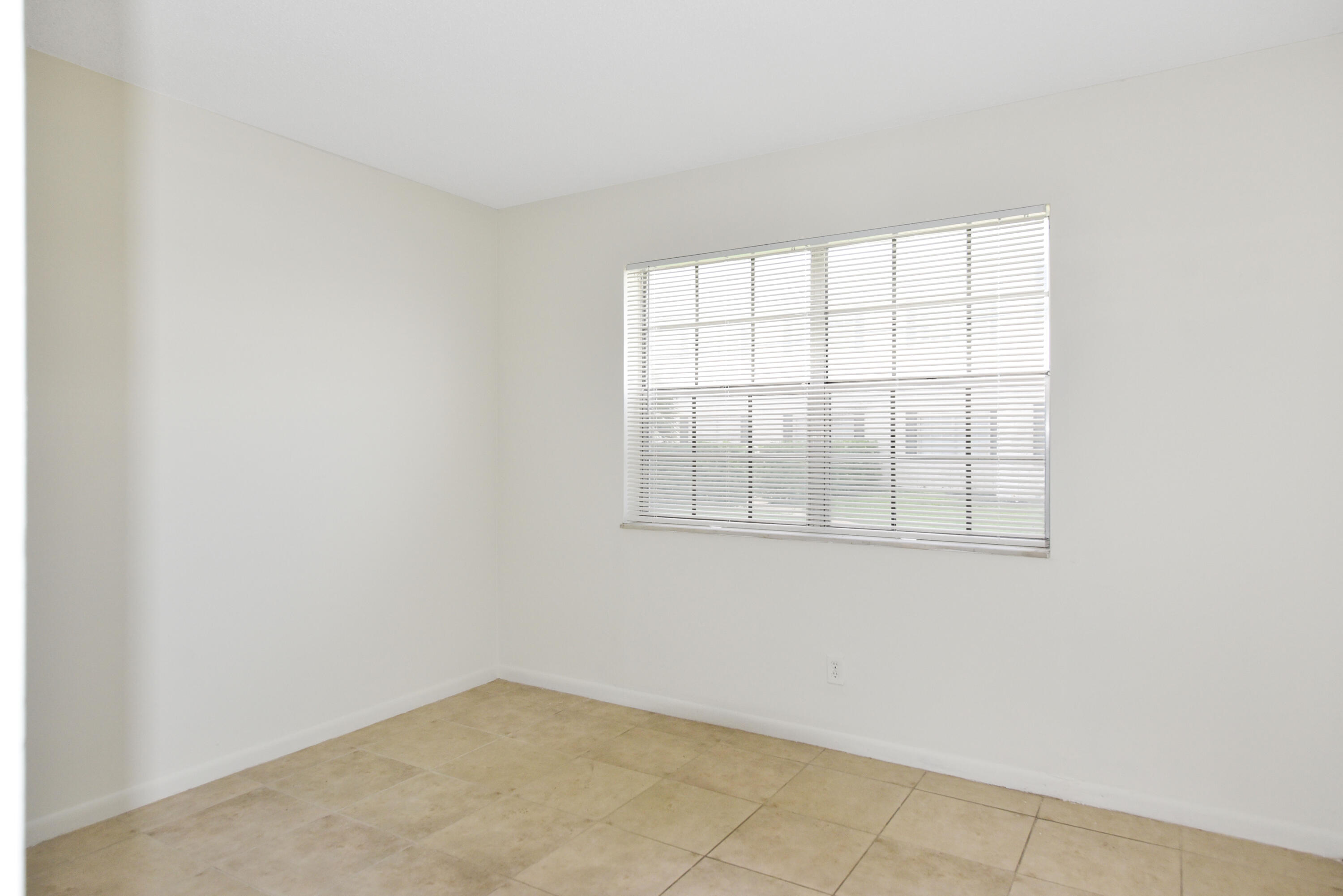 298 Southwest 6th Street, Unit 110 Boca Raton, FL 33432 - Photo 15 of 27 an empty room with windows