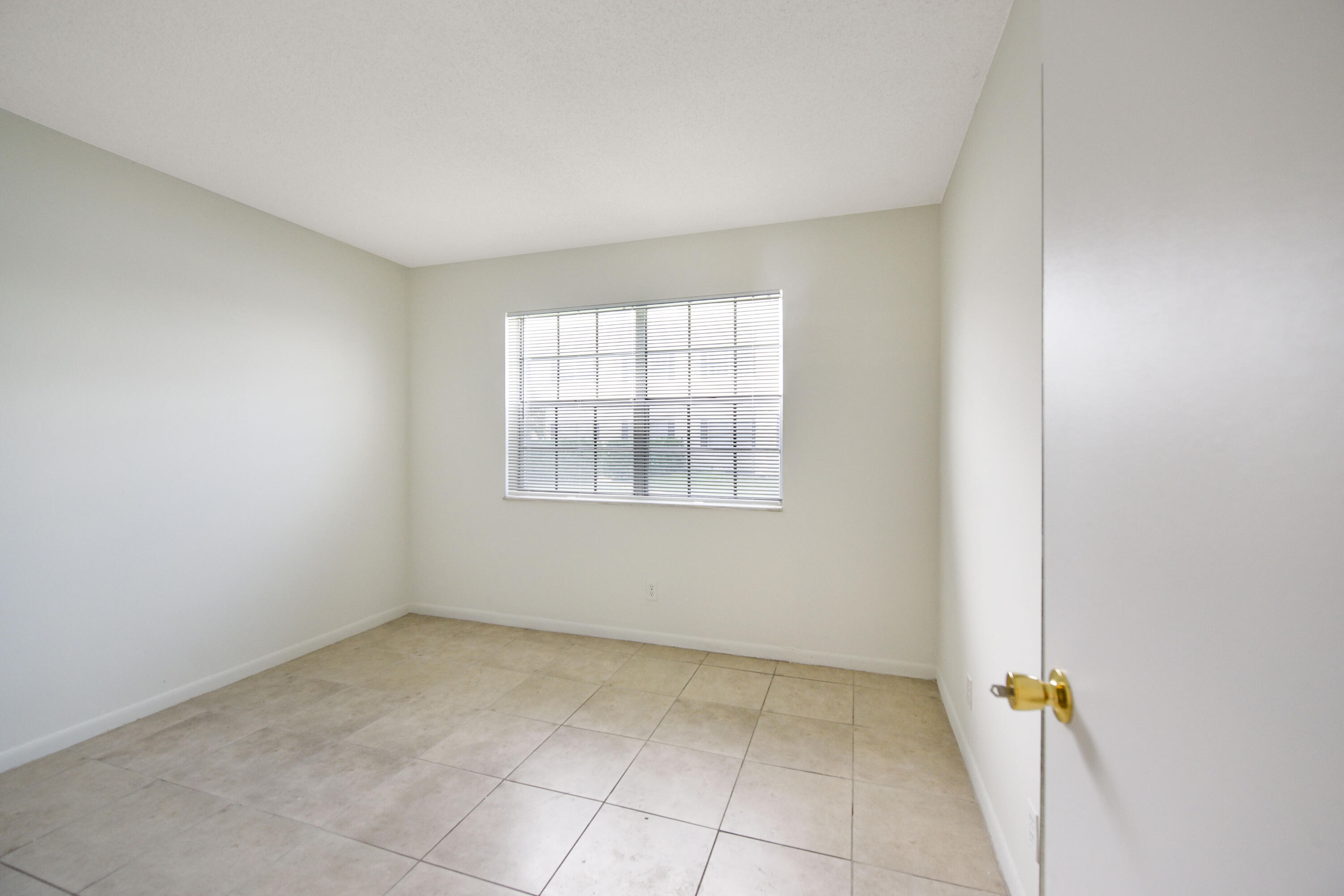298 Southwest 6th Street, Unit 110 Boca Raton, FL 33432 - Photo 16 of 27 an empty room with a window