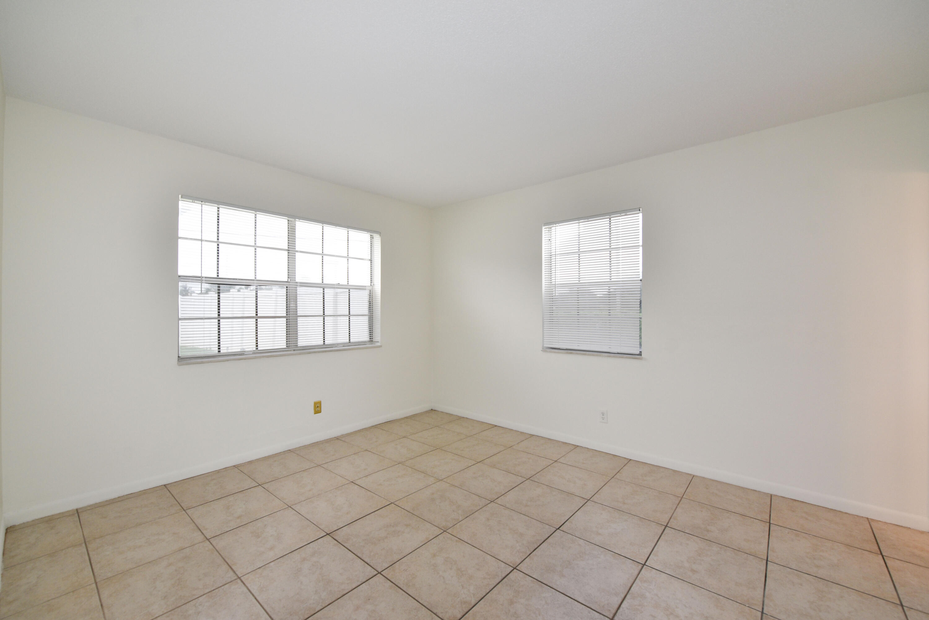 298 Southwest 6th Street, Unit 110 Boca Raton, FL 33432 - Photo 17 of 27 an empty room with windows